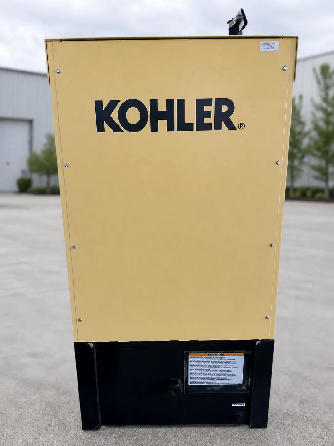 Kohler 15REOZK rear view showing enclosure panel, base tank, and oil drain access